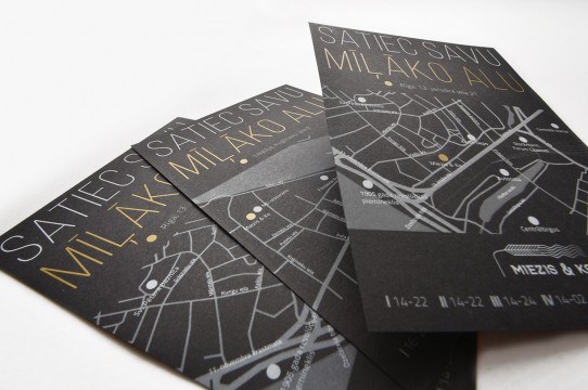 The flyer is printed with white and gold on black paper